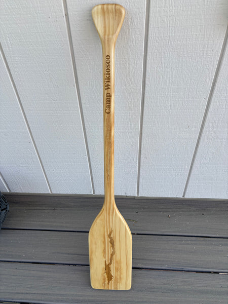 Wooden paddle with the silhouette of Lake George lasered on it.