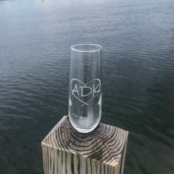 ADK in a heart on a stemless champagne flute