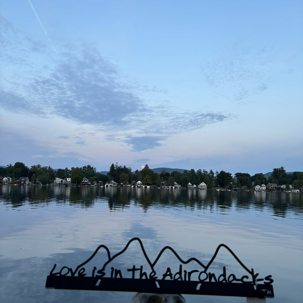 Love is in the Adirondacks text on the base with the outline of the Adirondack mountains cut out.