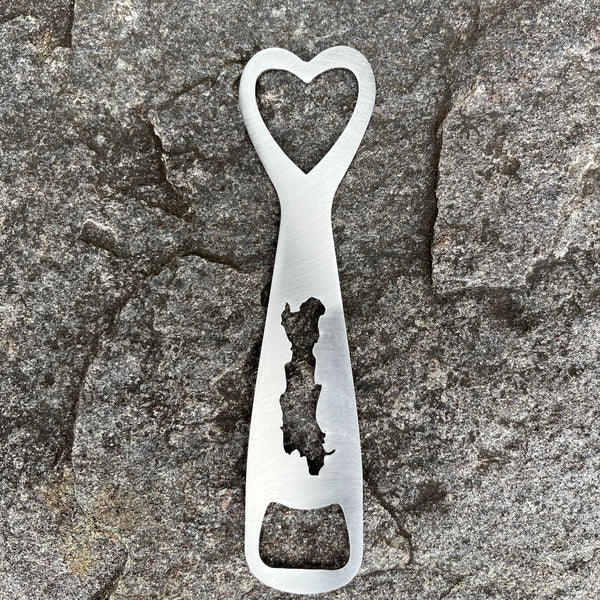 Silhouette of Friends Lake cut out on a stainless bottle opener.