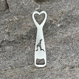 Silhouette of Loon Lake cut out on a stainless steel bottle opener.  It has a heart cutout at the top of the opener.