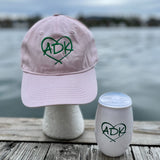 Pink ball cap with ADK in a heart embroidered in green.  White ADK Plastic cup with ADK in a heart in green.