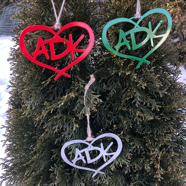 3 Adirondack metal ornaments. The design in ADK in a heart with a hand tied twine hanger. The set includes a red, green and stainless ornament.