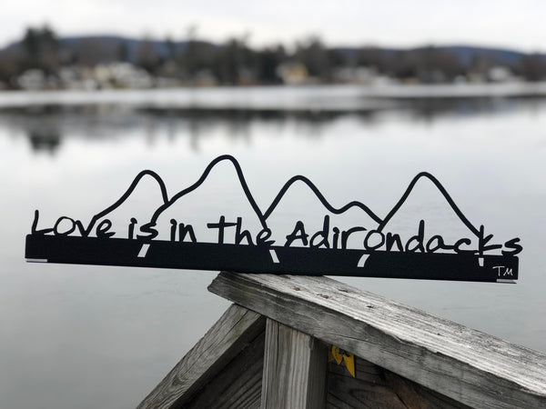 Love is in the Adirondacks text on the base with the outline of the Adirondack mountains cut out.