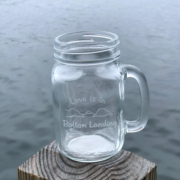 Glass handled mason jar with our lake and mountain graphic. Love is in Bolton Landing is the text.