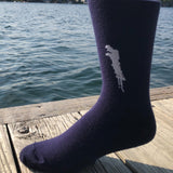 Silhouette of Brant Lake stitched in white on a unisex navy blue sock.