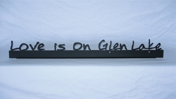 Love is on Glen Lake text on a black metal sign.