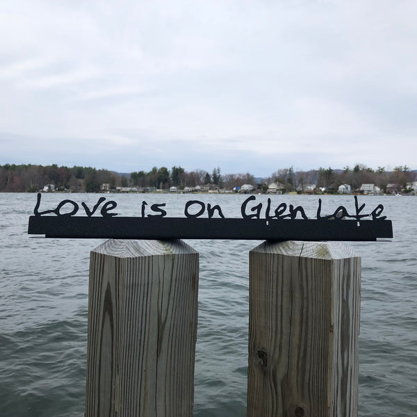 Love is on Glen Lake text on a black metal sign.