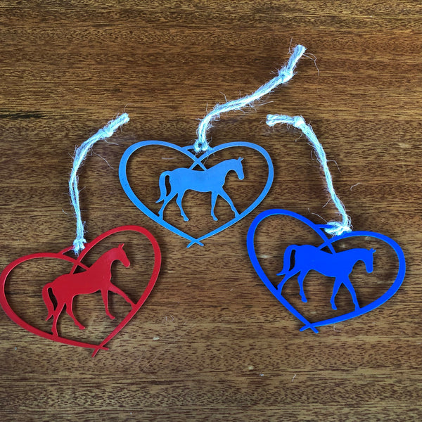 Heart Ornament with a Horse inside the heart hung with a hand tied twine hanger. Made of metal.