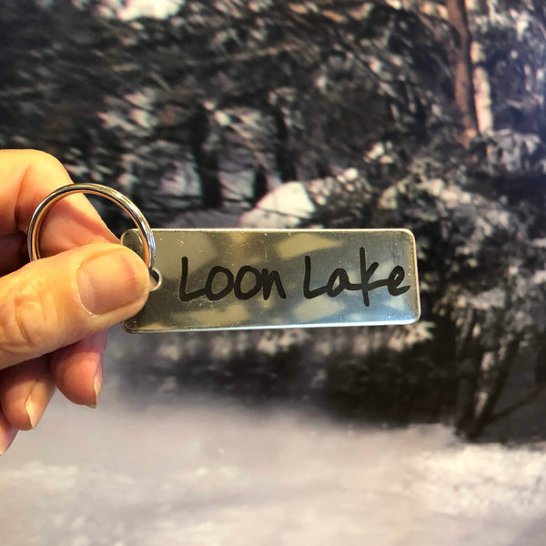 Loon Lake Text laser etched on a stainless steel key tag.
