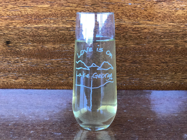 Love is on Lake George text sand blasted on a stemless champagne flute with the Lake and mountain outline.