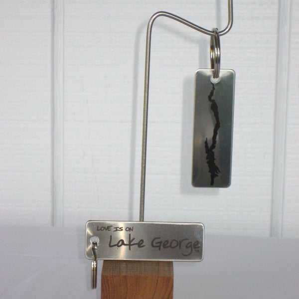 Love is on Lake George text on oneside of this stainless steel key ring. Silhouette of Lake George on the other side.