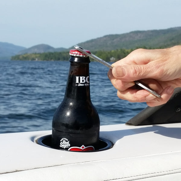 Metal bottle opener with a heart cut out on the top, silhouette of Glen Lake cut out in the body, and bottle opener cut out at the bottom.