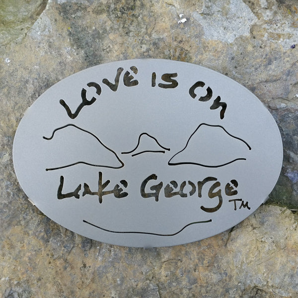 Text Love is on Lake George with the outline of the lake and surrounding Adirondack mountains; color is gold haze.