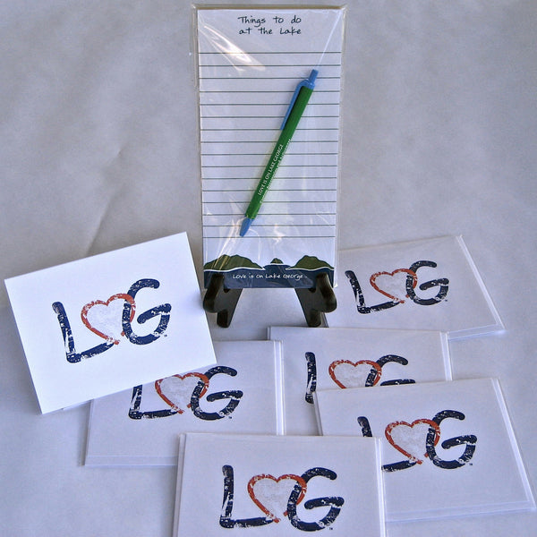 The letters LG connected with an interlocking heart on a white note card. Comes with an envelope suitable for mailing. Note pad says Things to do with the Lake and Mountain scene on the bottom of the note pad.