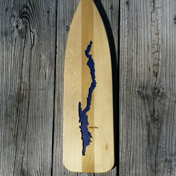Silhouette of Lake George milled out of a canoe oar; the lake is painted blue.