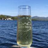 Love is on Lake George text sand blasted on a stemless champagne flute with the Lake and moutain outline.