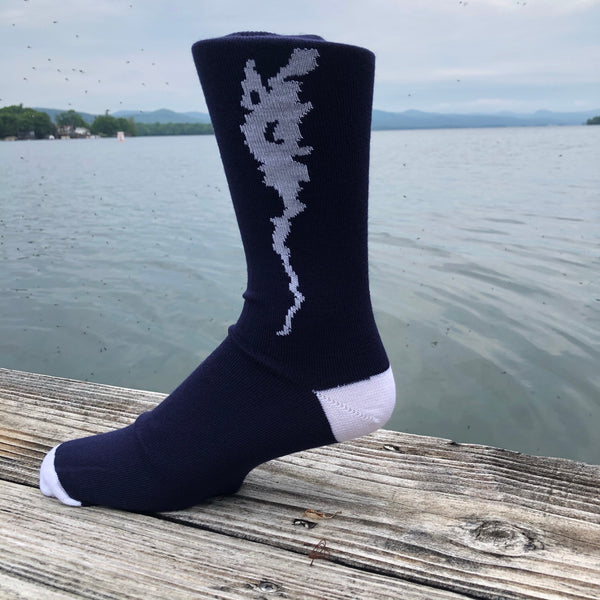 Silhouette of Lake Champlain stitched in white on a navy blue crew length sock.