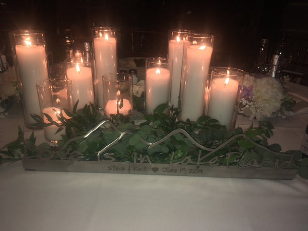 Love is in Lake Placid text on a stainless sign with Mountains.