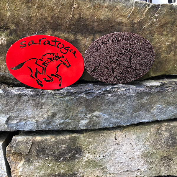 Two Saratoga trivets with Saratoga text arched over a jockey riding a horse; Color red and Copper