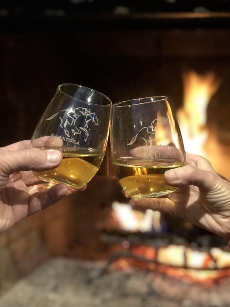 Jockey riding a horse with the text Saratoga on a pair of Stemless wine glasses.