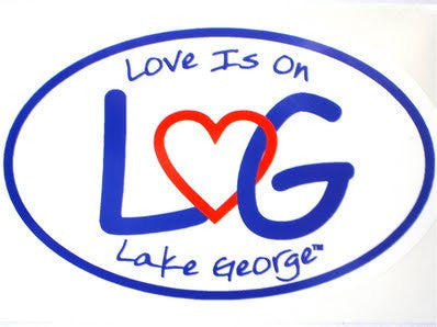 Arched text Love is on Lake George above and below the letters LG connected with an interlocking heart.