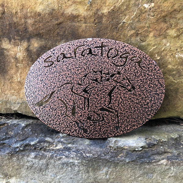 Saratoga text arched over a jockey riding a horse; Color copper pebble