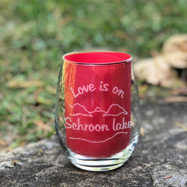 Clear stemless wine glass with a lake and mountain scene. Text reads Love is on Schroon Lake