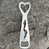 Silhouette of Schroon Lake cut out on a stainless bottle opener.