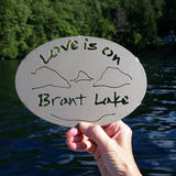 Text Love is on Brant Lake text with the outline of the lake and surrounding Adirondack mountainscape.