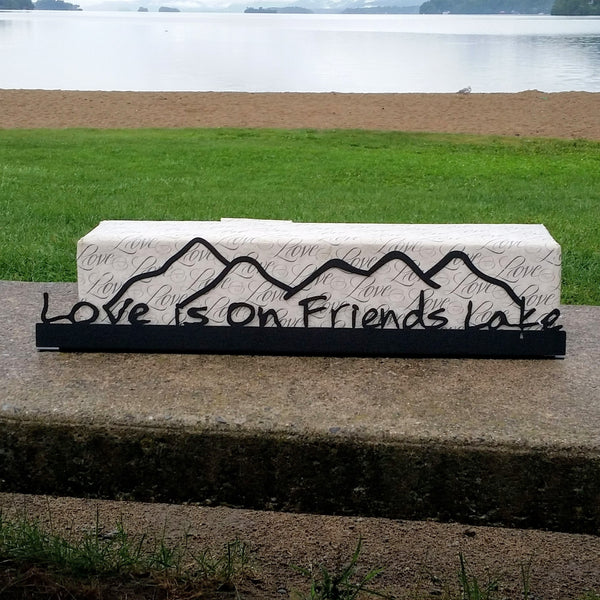 Love is on Friends Lake text on the base with the outline of the Adirondack mountains cut out.