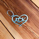 Stainless key chain with ADK inside a heart.