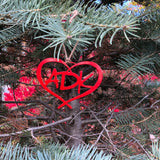 ADK in a heart metal ornament with a natural hemp hand tied hanger; color red.