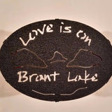 Text Love is on Brant Lake text with the outline of the lake and surrounding Adirondack mountainscape