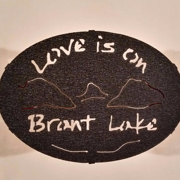 Text Love is on Brant Lake text with the outline of the lake and surrounding Adirondack mountainscape