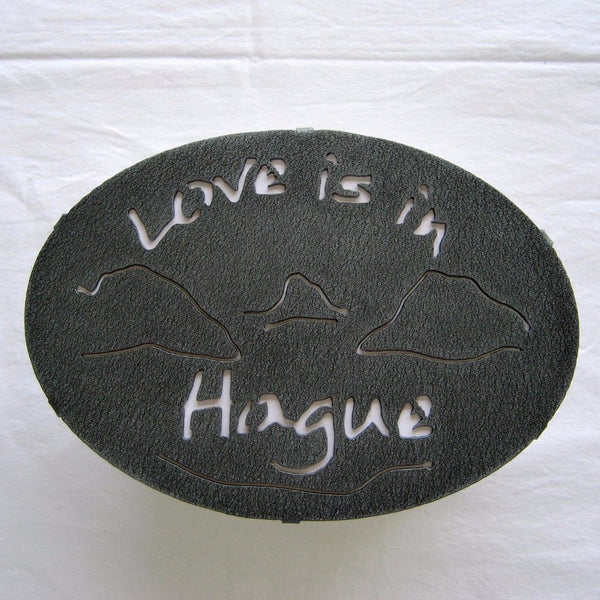 Text Love is in Hague text with the outline of the lake and surrounding Adirondack mountainscape
