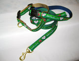 Dog collar with our ADK in a heart logo, a dog bone and the Adirondacks on a ribbon with webbing on the other side of the dog collar.