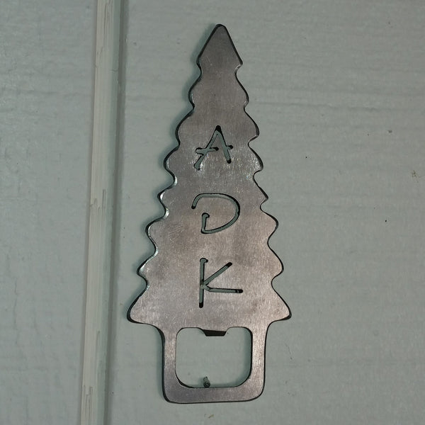 Handcrafted stainless steel bottle opener with a ADK cut out of an Adirondack evergreen tree. The bottle opener tab is at the base of the tree.