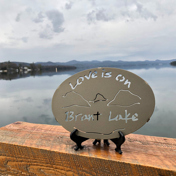 Text Love is on Brant Lake text with the outline of the lake and surrounding Adirondack mountainscape.