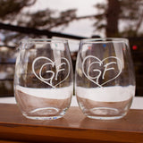 A pair of clear stemless wine glass with our GF logo inside a heart. 