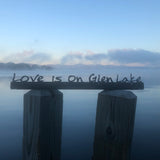 Love is on Glen Lake text on a black metal sign.