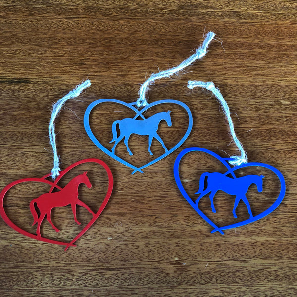 Heart Ornament with a Horse inside the heart  hung with a  hand tied twine hanger. Made of metal.