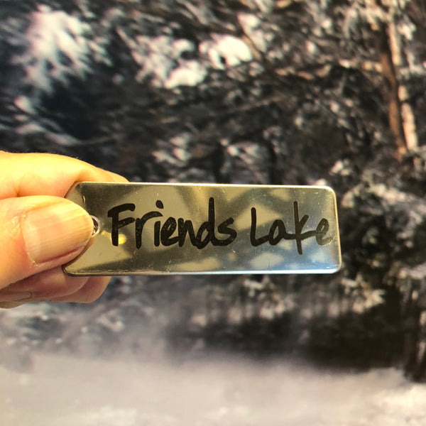 Friends Lake text laser etched on a stainless key chain.