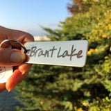 Brant Lake text on a stainless key ring.
