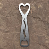 Metal bottle opener with a heart cut out on the top, silhouette of Lake George cut out in the body, and bottle opener cut out at the bottom.