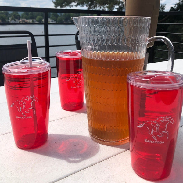 Jockey on a horse with Saratoga spelled out underneath the graphic on a red tumbler with white lettering.