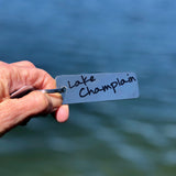 Lake Champlain text on a stainless keychain.