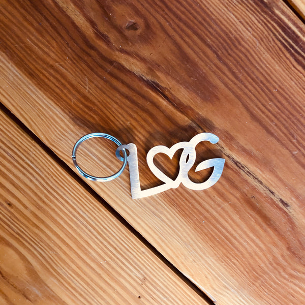Stainless Steel key chain with a heart intertwined between the letters LG.G.