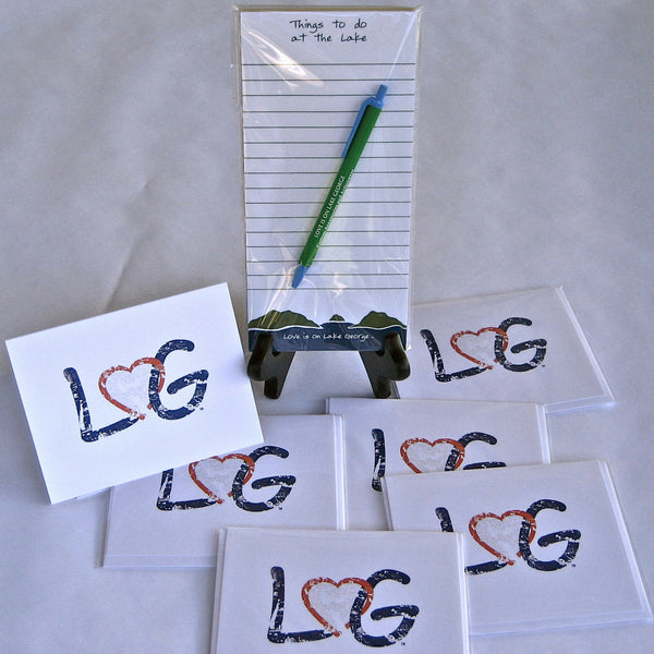 The letters LG connected with an interlocking heart on a white note card. Comes with an envelope suitable for mailing.  Note pad says Things to do with the Lake and Mountain scene on the bottom of the note pad.