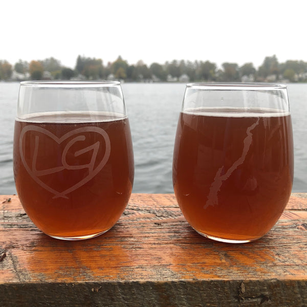 Two-sided stemless wine glass featuring our LG in a heart Logo on one side; the silhouette of Lake George on the other side.